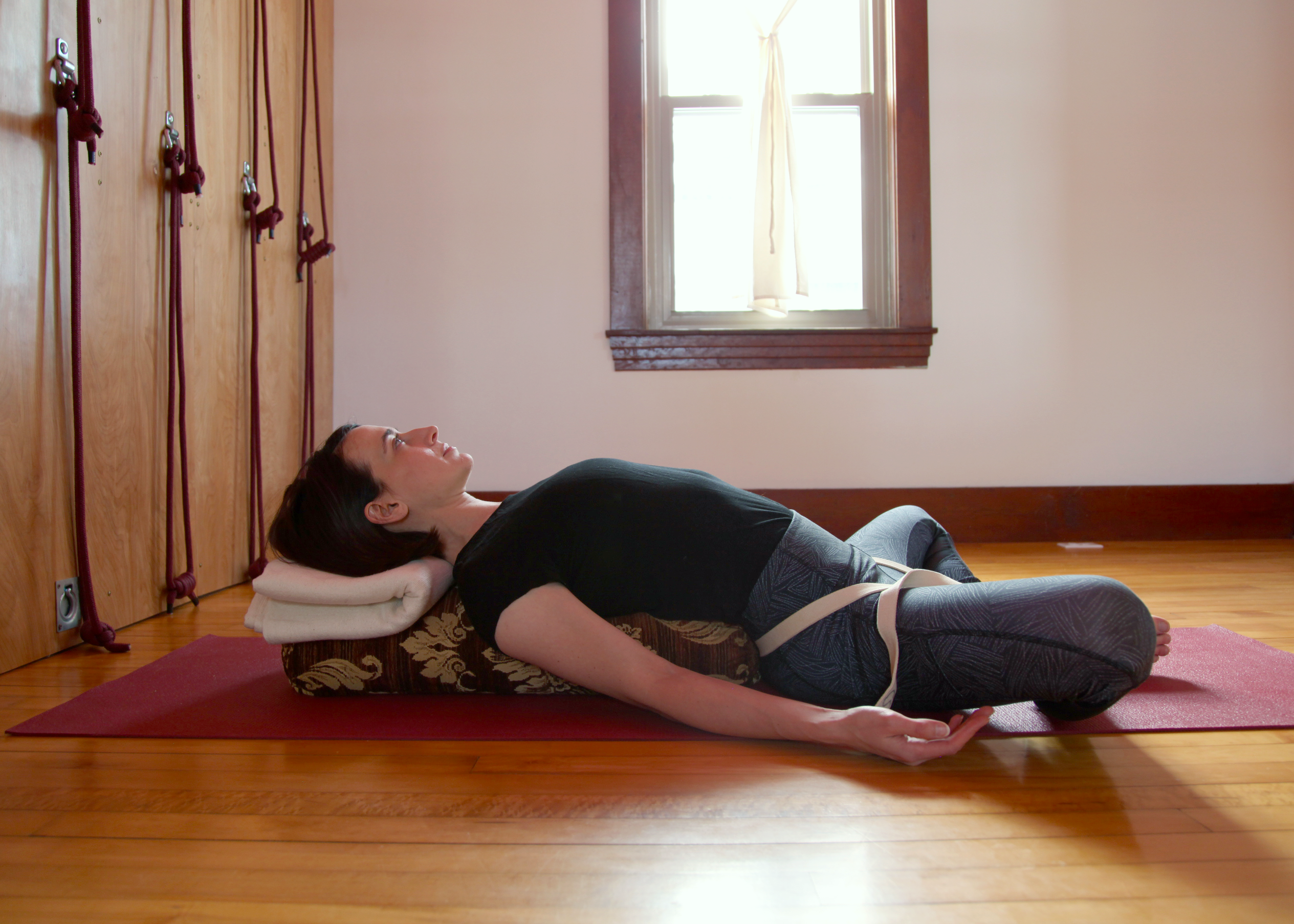 person doing Supta Baddha Konasana yoga pose